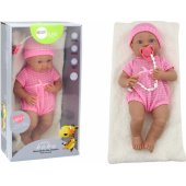Baby doll in pink clothes, hat, pacifier, and blanket